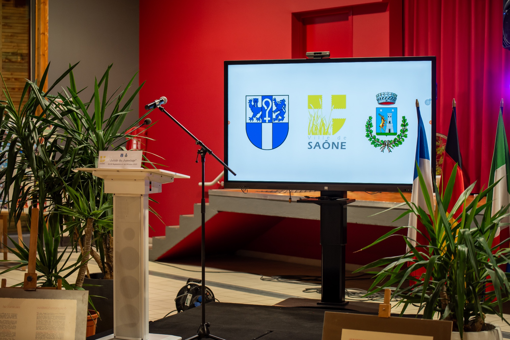 Scène d'un événement professionnel avec podium et écran à Saône
